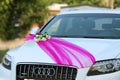 Gomel, Republic of Belarus, August 08, 2014: A white Audi car is decorated with wedding decorations. Wedding cortege