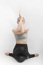 Gomukhasana. Cow Face Pose. Beautiful young woman practices yoga asanas. Slender sports girl does hatha yoga