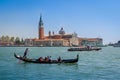 Gondola boat and San Giorgio popular touristic island in Venice