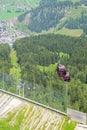 Gondola cars on steep piste to the valley Royalty Free Stock Photo