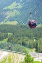 Gondola cars on steep piste to the valley Royalty Free Stock Photo