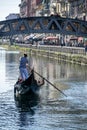 Gondola and gondolier in the Darsena del Naviglio in Milan, Italy.