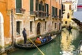 Gondola with gondolier and tourists in Venice Royalty Free Stock Photo