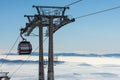 Gondola lift. Cabin of ski-lift in the ski resort in the early morning at dawn with mountain peak in the distance Royalty Free Stock Photo