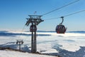 Gondola lift. Cabin of ski-lift in the ski resort in the early morning at dawn with mountain peak in the distance Royalty Free Stock Photo