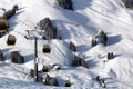 Gondola lift. Cabin of ski-lift in the ski resort in the early morning at dawn with mountain peak in the distance. Winter Royalty Free Stock Photo