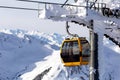 Gondola lift. Cabin of ski-lift in the ski resort in the early morning at dawn with mountain peak in the distance. Winter Royalty Free Stock Photo