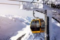 Gondola lift. Cabin of ski-lift in the ski resort in the early morning at dawn with mountain peak in the distance. Winter Royalty Free Stock Photo