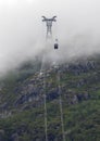 Gondola lift heading into the mist on the way to the top.