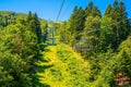 the gondola lift to a forest top ski area in the mountains Royalty Free Stock Photo