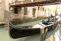 Gondola moored under bridge