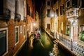 Gondola moving over a small canal in Venice at night. 03/03/2017 - Venice, Italy