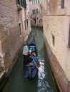 Gondola in a narrow canal of Venice