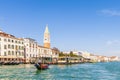 A gondola near a vaporetto station on the Grand Canal and in the distance the campanile of St. Mark`s Square, Venice, Veneto, Ital Royalty Free Stock Photo