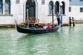 Gondola with Passengers Navigating Venetian Canal Royalty Free Stock Photo