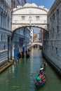 A gondola passes under the famous `Bridge of Sighs` at the Doge`s Palace in the Italian city of Venice Royalty Free Stock Photo
