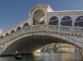 A gondola passes under the Rialto Bridge of Venice, Italy Royalty Free Stock Photo