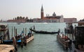 Gondola passing by the Riva degli Schiavoni embankment, Venice, Italy