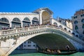 Gondola passing under Rialto Bridge Ponte de Rialto across Grand Canal, Venice, Italy Royalty Free Stock Photo