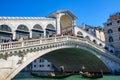 Gondola passing under Rialto Bridge Ponte de Rialto across Grand Canal, Venice, Italy Royalty Free Stock Photo