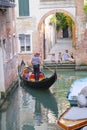 Gondola sails down the channel in Venice