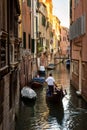 Gondola sails past vintage houses, Venice, Italy. Vertical view of old street in the Venice city