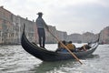 Man driving gondola boat in Venice, Italy