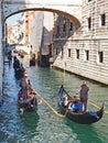 Gondoliers ferry passengers in gondolas on the crowded canals of Venice Royalty Free Stock Photo