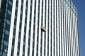 Gondola with window cleaners on skyscraper Royalty Free Stock Photo