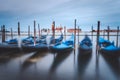 Gondolas floating in the Grand Canal in front of San Giorgio Maggiore church in background. Long exposure picture Royalty Free Stock Photo