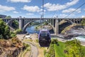 Gondolas fly over the Spokane River and falls near Riverfront Park on a summer day in Spokane, Washington, USA