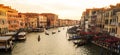 Gondolas with gondoliers and passengers lineup in Grand Canal view from Ponte Rialto Rialto Bridge, Venice at sunset, Italy.