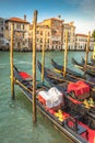 Gondolas in Grand Canal stake pier at golden sunset, Venice, Italy Royalty Free Stock Photo