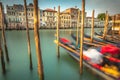 Gondolas in Grand Canal stake pier at golden sunset, Venice, Italy Royalty Free Stock Photo