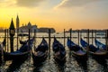 Gondolas on the jetty of San Marco square in Venice at sunset