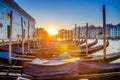 Gondolas moored docked on pier of Grand Canal waterway in Venice Royalty Free Stock Photo