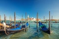 Gondolas Moored Docked On Water In Venice. Gondoliers Sailing San Marco Basin Waterway. San Giorgio Maggiore Island