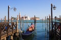 Gondolas moored on the pier of Saint Mark square, in the background is San Giorgio di Maggiore church, Venice, Italy Royalty Free Stock Photo