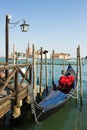 Gondolas moored on the pier of Saint Mark square, in the background is San Giorgio di Maggiore church, Venice, Italy Royalty Free Stock Photo