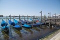 Gondolas moored by Saint Mark square with San Giorgio di Maggiore church in Venice, Italy - June 20, 2017 Royalty Free Stock Photo