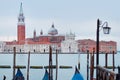 Gondolas moored by Saint Mark square with San Giorgio di Maggiore church on the background Royalty Free Stock Photo