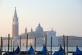 Gondolas moored by Saint Mark square with San Giorgio di Maggiore church in the background - Venice, Venezia, Italy, Europe Royalty Free Stock Photo