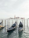 Gondolas moored by Saint Mark square with San Giorgio di Maggiore church in the background - Venice, Venezia, Italy Royalty Free Stock Photo