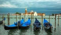 Gondolas moored by Saint Mark square with San Giorgio di Maggiore church Royalty Free Stock Photo