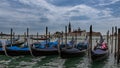 Gondolas moored by Saint Mark square with San Giorgio di Maggiore church in Venice, Italy. Royalty Free Stock Photo