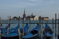 Gondolas moored by Saint Mark square and San Giorgio Maggiore Island with Basilica Santa Maria della Salute in the background, V Royalty Free Stock Photo