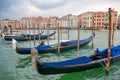 Gondolas moored to the wooden pier