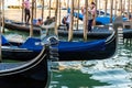 Gondolas Moored at a Venetian Dock with Gondoliers Royalty Free Stock Photo