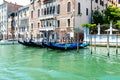 Gondolas Moored by Venetian Palaces on Calm Canal Royalty Free Stock Photo