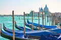 Gondolas with mooring poles and Santa Maria della Salute church n Venice Royalty Free Stock Photo